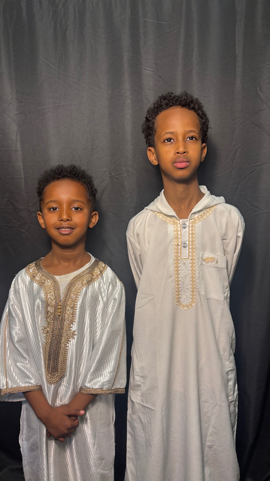 Two Ibn Masud students in traditional thobes