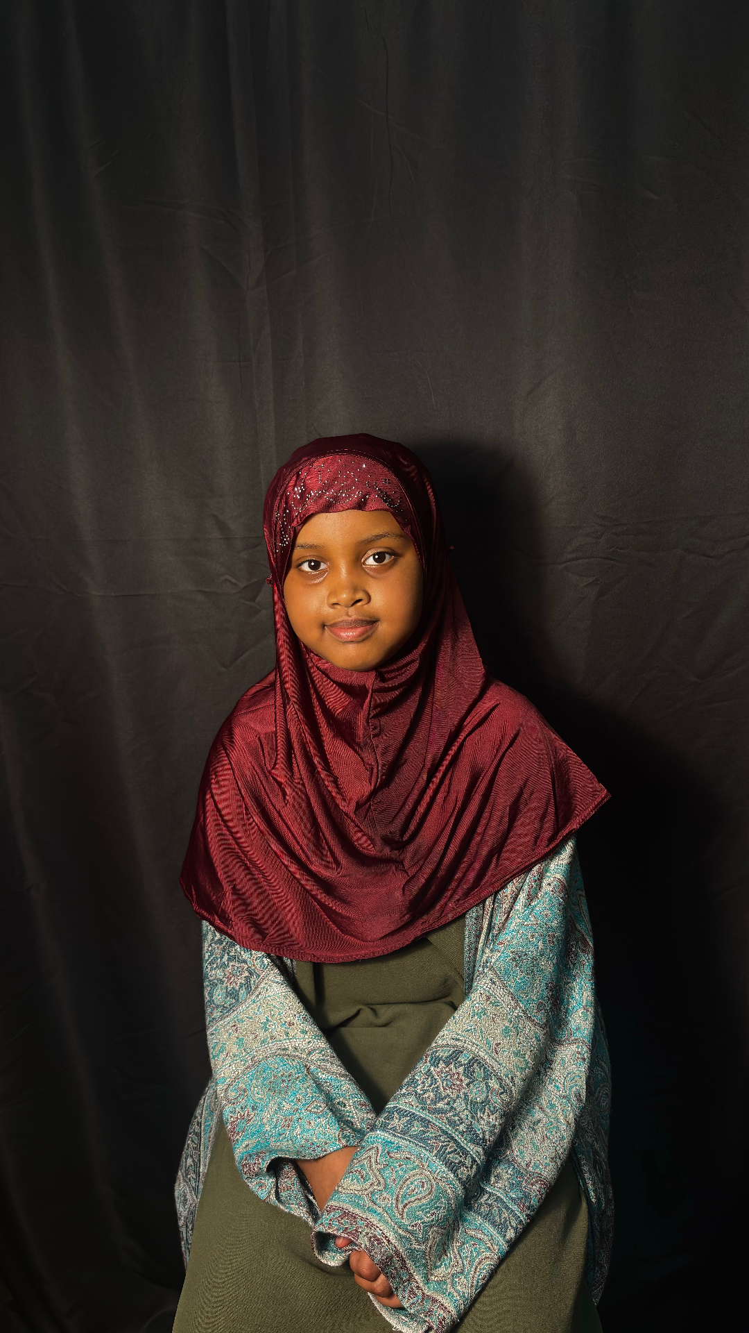 Ibn Masud student wearing a maroon hijab